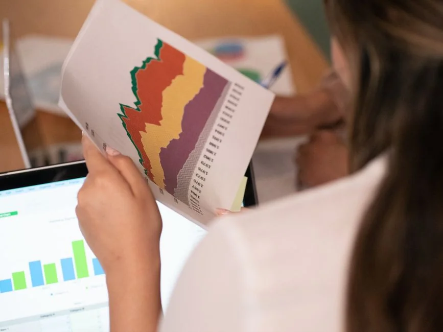 Two colleagues work together on a marketing strategy with a whiteboard, with a focus on user-generated content.
